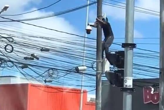 Ousadia: homem é flagrado escalando poste para remover câmera de segurança em plena luz do dia; VEJA VÍDEO