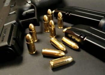 View of a gun and bullets on a dark background, photo