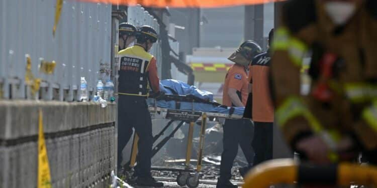 Emergency personnel transport the body of a victim at the scene of a fire at a lithium battery factory owned by South Korean battery maker Aricell in Hwaseong on June 24, 2024. Around 20 bodies have been found at a South Korean lithium battery factory after a massive blaze on June 24, the Yonhap news agency said, with firefighters saying they were still searching the building. (Photo by ANTHONY WALLACE / AFP)