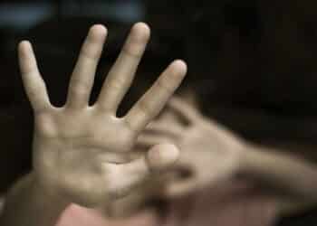Boy showing STOP gesture with his hand. Concept of domestic violence and child abuse. Copy space