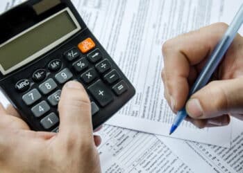 Cropped image of  Businessman calculating and checking tax