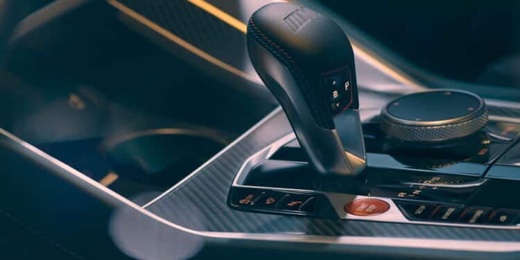 The gearbox and center console of the new BMW XM. The cockpit is finished in carbon fiber. Close up. Blurry effect. Poland, Katowice, 19.11.2022