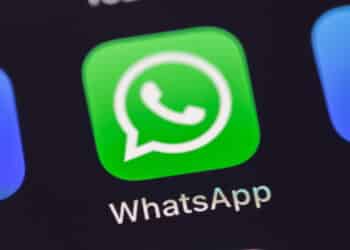 WhatsApp mobile icon app on the screen smartphone iPhone closeup. WhatsApp is a popular free instant text messaging system for mobile and other platforms. Batumi, Georgia - March 3, 2023