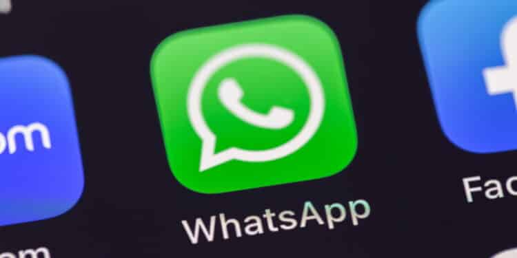 WhatsApp mobile icon app on the screen smartphone iPhone closeup. WhatsApp is a popular free instant text messaging system for mobile and other platforms. Batumi, Georgia - March 3, 2023