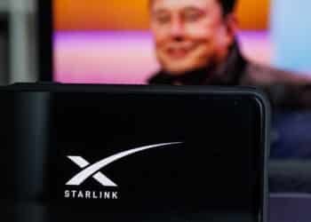 Kaunas, Lithuania - 14 October 2022: Starlink logo on screen and Elon Musk in background. High quality photo