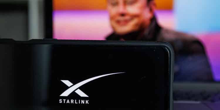 Kaunas, Lithuania - 14 October 2022: Starlink logo on screen and Elon Musk in background. High quality photo