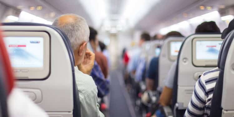 Interior of airplane with passengers on seats waiting to taik off.