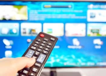 Smart tv and  hand pressing remote control