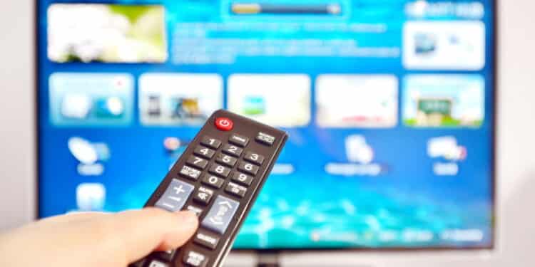 Smart tv and  hand pressing remote control