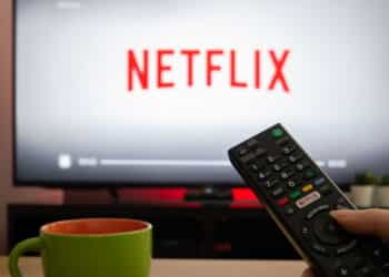 UK, March 2020: TV Television white netflix background with remote control