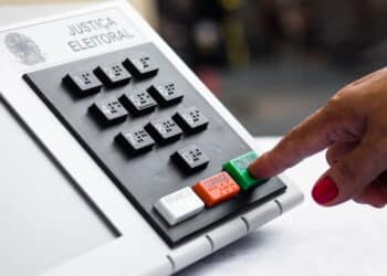 November 16, 2020, Brazil. In this photo illustration a woman simulates a vote in the electronic ballot box used in the elections of Brazil