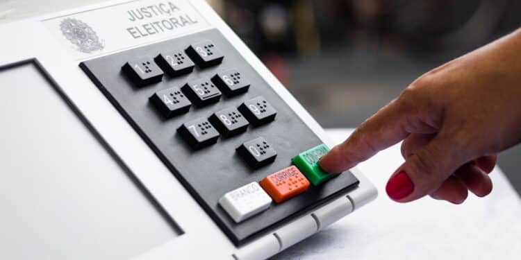 November 16, 2020, Brazil. In this photo illustration a woman simulates a vote in the electronic ballot box used in the elections of Brazil