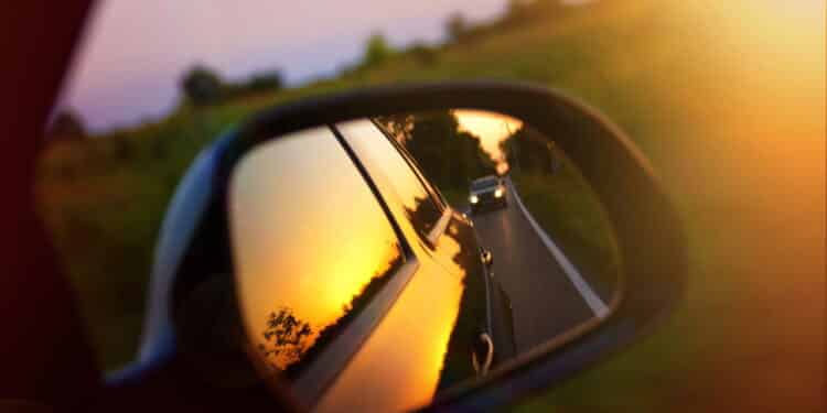 Driving at sunset - peek into a rear view mirror