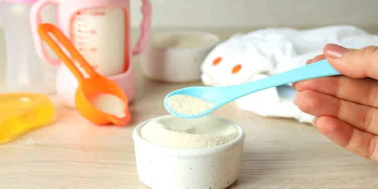 Concept of baby food with рowdered milk on wooden table