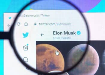 May 22, 2022, Brazil. In this photo illustration Elon Musk official Twitter profile seen on a computer screen through a magnifying glass