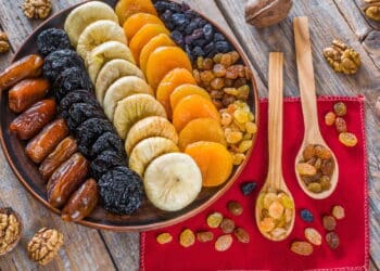 Different dried fruits on a plate on a wooden table