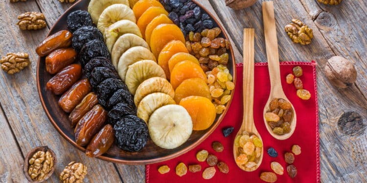 Different dried fruits on a plate on a wooden table