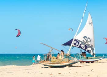 Cumbuco, Brazil, jul 9, 2017: Moored jangada boat over the white sandy beach in Brazil