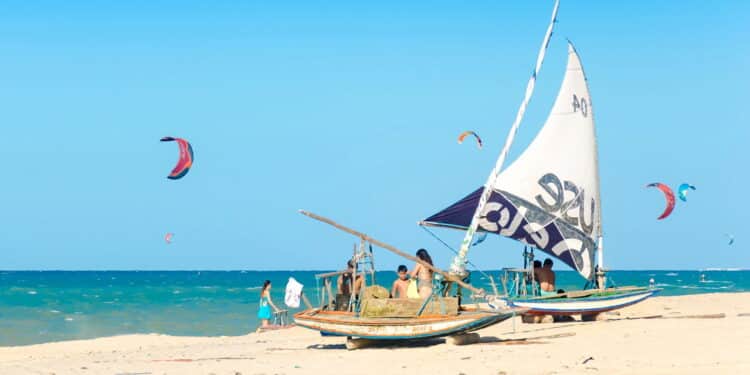 Cumbuco, Brazil, jul 9, 2017: Moored jangada boat over the white sandy beach in Brazil