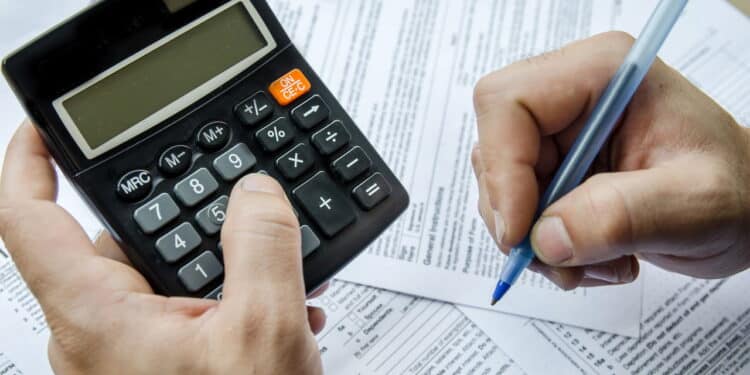 Cropped image of  Businessman calculating and checking tax