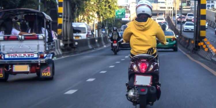 Motorcycle and cars are riding on street