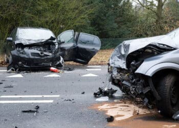 Two cars who crashed into another car on a interstate road