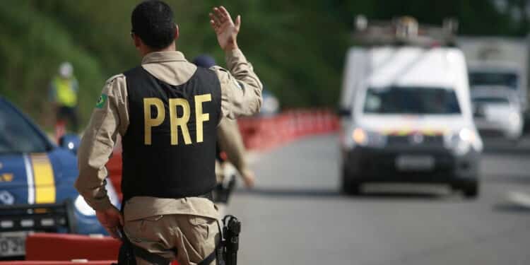 SALVADOR, BAHIA / BRAZIL - January 6, 2015: Federal Highway Police (PRF) agent is seen alongside the car on the BR 324 federal highway in Salvador (BA).