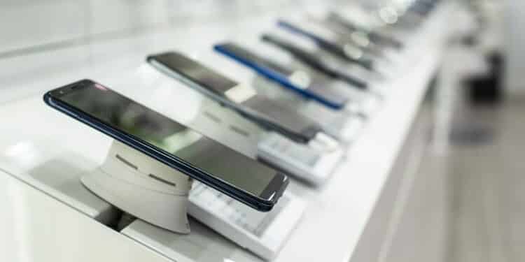 Smartphones on shelf in the store. Concept for communications and technology. Buying mobile phone in technology shop.