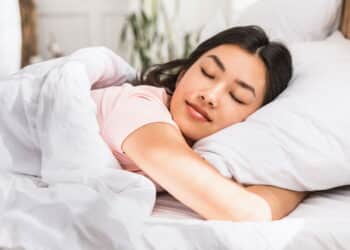 Healthy Sleep. Relaxed Asian Girl Sleeping Hugging Pillow Resting Lying In Comfortable Bed At Home.