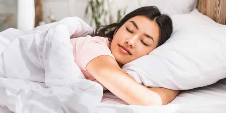 Healthy Sleep. Relaxed Asian Girl Sleeping Hugging Pillow Resting Lying In Comfortable Bed At Home.