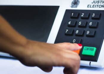 November 16, 2020, Brazil. In this photo illustration a woman simulates a vote in the electronic ballot box used in the elections of Brazil