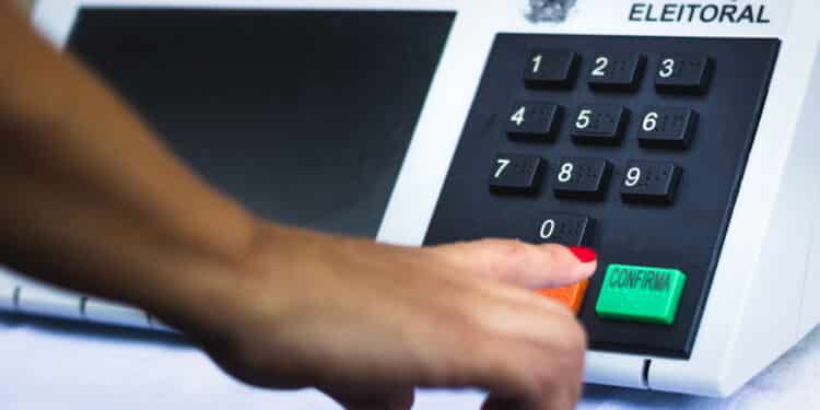 November 16, 2020, Brazil. In this photo illustration a woman simulates a vote in the electronic ballot box used in the elections of Brazil