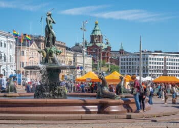 Helsinki, Finland - Jun 30, 2019: Market Square with Havis Amanda Fountain and Uspenski Cathedral on background - Helsinki, Finland