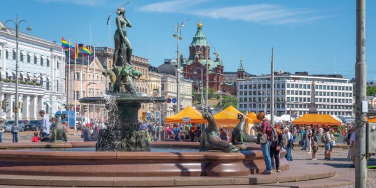 Helsinki, Finland - Jun 30, 2019: Market Square with Havis Amanda Fountain and Uspenski Cathedral on background - Helsinki, Finland