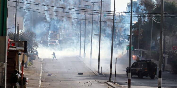 WEST BANK, Bethlehem: Tear gas and smoke from burning tires fill the streets of Bethlehem in the West Bank as clashes continued every Friday between Israeli forces and Palestinian protesters on February 5, 2016.