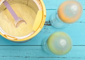 can of powdered milk with two baby bottles