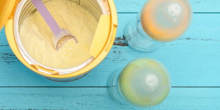 can of powdered milk with two baby bottles