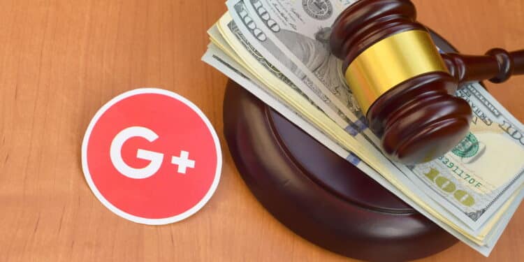 KHARKOV, UKRAINE - FEBRUARY 17, 2020: Google plus paper logo lies with judge gavel and hundred dollar bills. Entertainment lawsuit concept