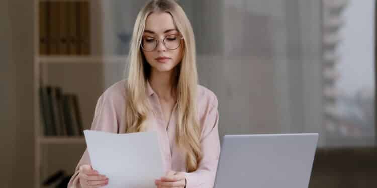 Caucasian business woman distance teacher manager boss leader online coach lawyer consultant secretary specialist professional working with documents and laptop in home office checks data in report. High quality 4k footage