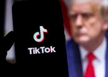 August 1, 2020, Brazil. In this photo illustration the TikTok logo seen displayed on a smartphone. United States President Donald Trump appears in the background. He said he will ban TikTok in the USA