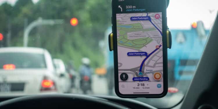 An iPhone X with Waze navigation app inside the car. Waze has gain popularity for its good navigation.