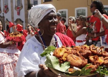 Imagem de baiana segurando tabuleiro com acarajé - Créditos: depositphotos.com / joasouza