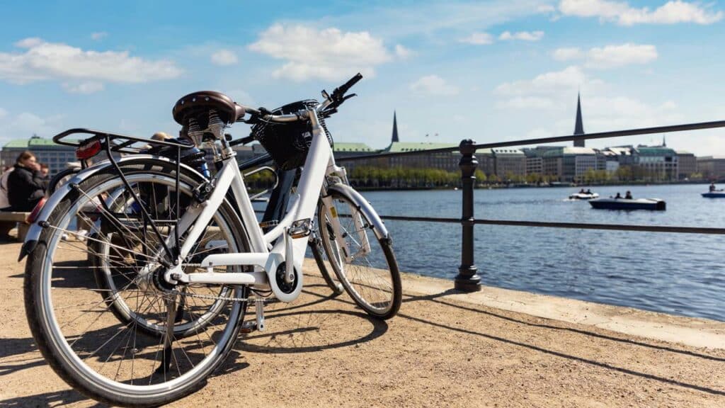 Vista panorâmica de duas bicicletas modernas estacionadas na margem do lago Alster, em Hamburgo - Créditos: depositphotos.com / gorlovkv