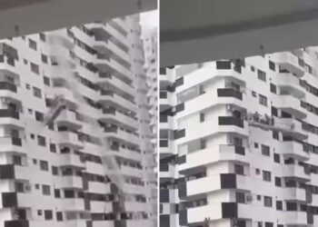 Trabalhadores ficam presos em andaime durante ventania — Foto: Vídeo do leitor