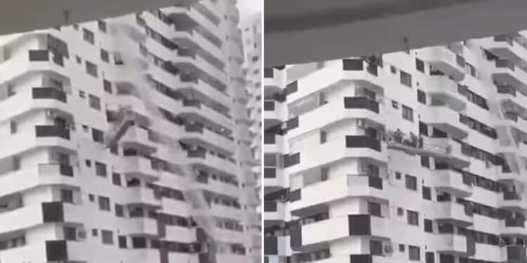 Trabalhadores ficam presos em andaime durante ventania — Foto: Vídeo do leitor