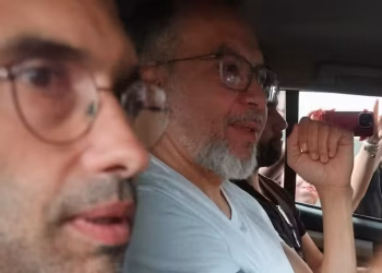 Deputado eleito Marcio Canella (de camiseta branca e barba) chega à sede da PF — Foto: Fabiano Rocha